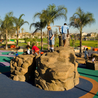 Children Playing on the Rock Structure in the Play Area