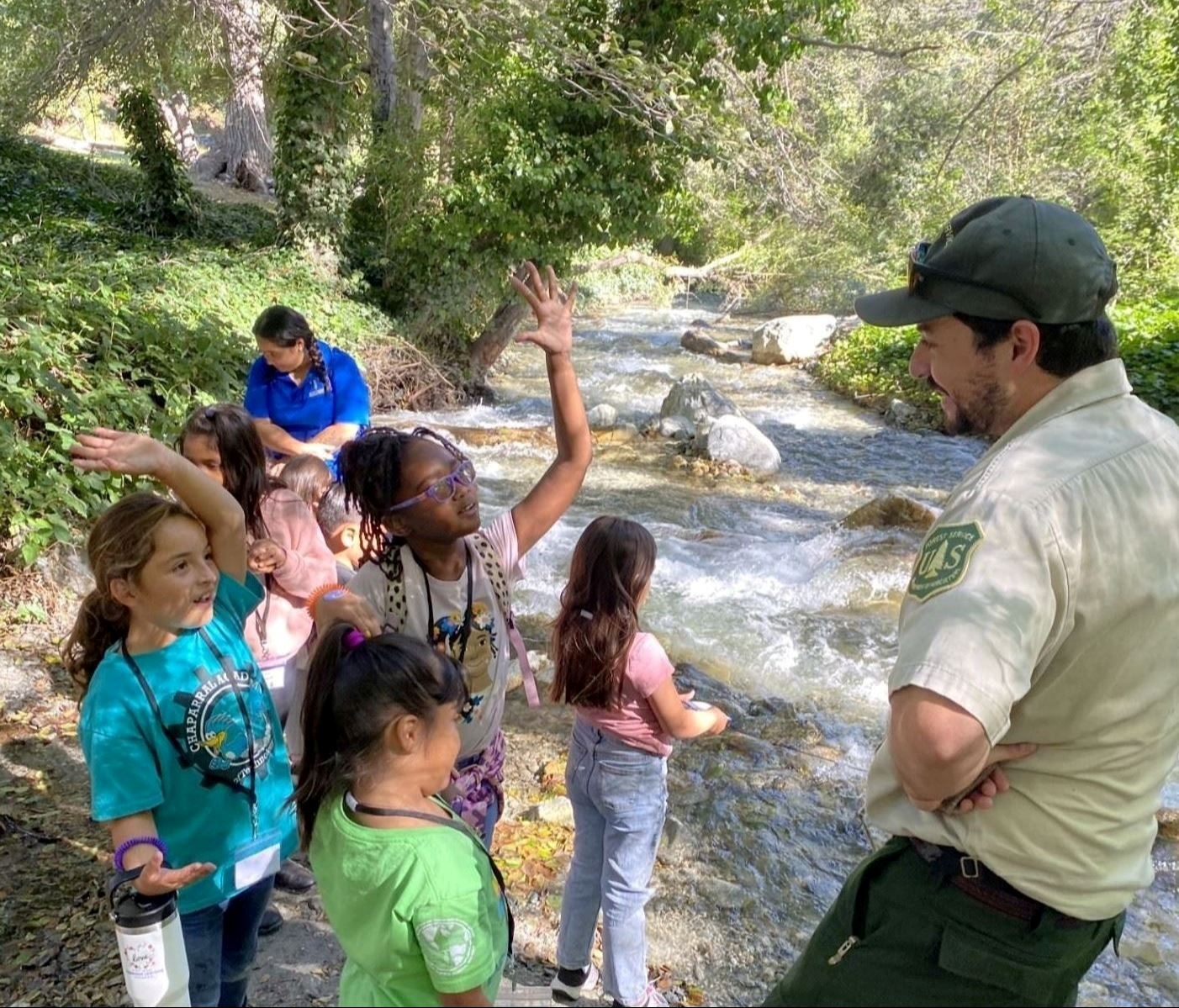 group of students learning from staff member about nature around them